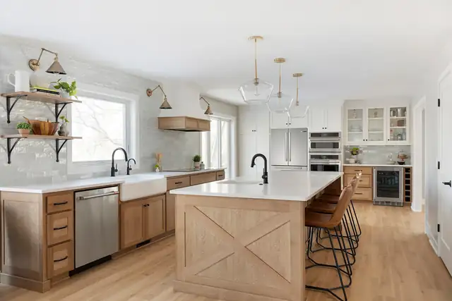 Eagan modern farmhouse kitchen with wood base cabinets, white oak island with X-brace panel, apron sink and open shelves