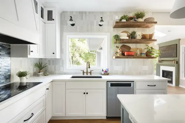 Eagan kitchen with white cabinets, a tiled backsplash, brass sconces, open wood shelves and a quartz counter