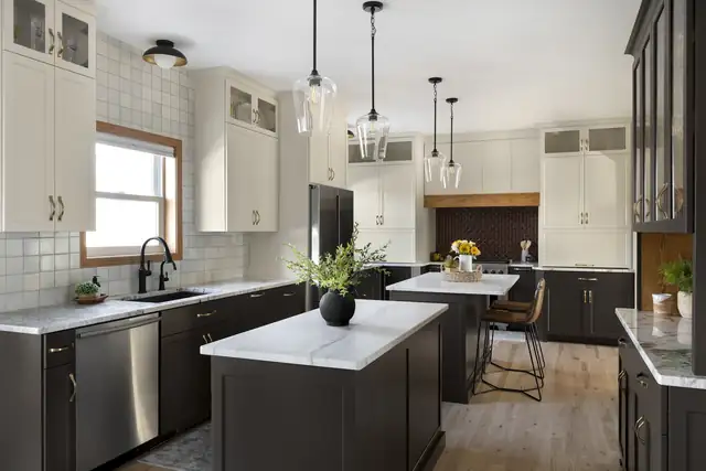 Eagan kitchen remodel with charcoal lower cabinets, white uppers, two islands and glass pendant lights